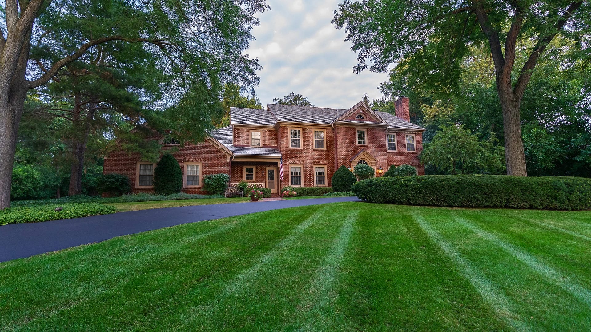 Clean but formal lines. The lush green lawn areas play off the formal boxwood and pachysandra groundcover, providing a calming feel for guests upon arrival to property.