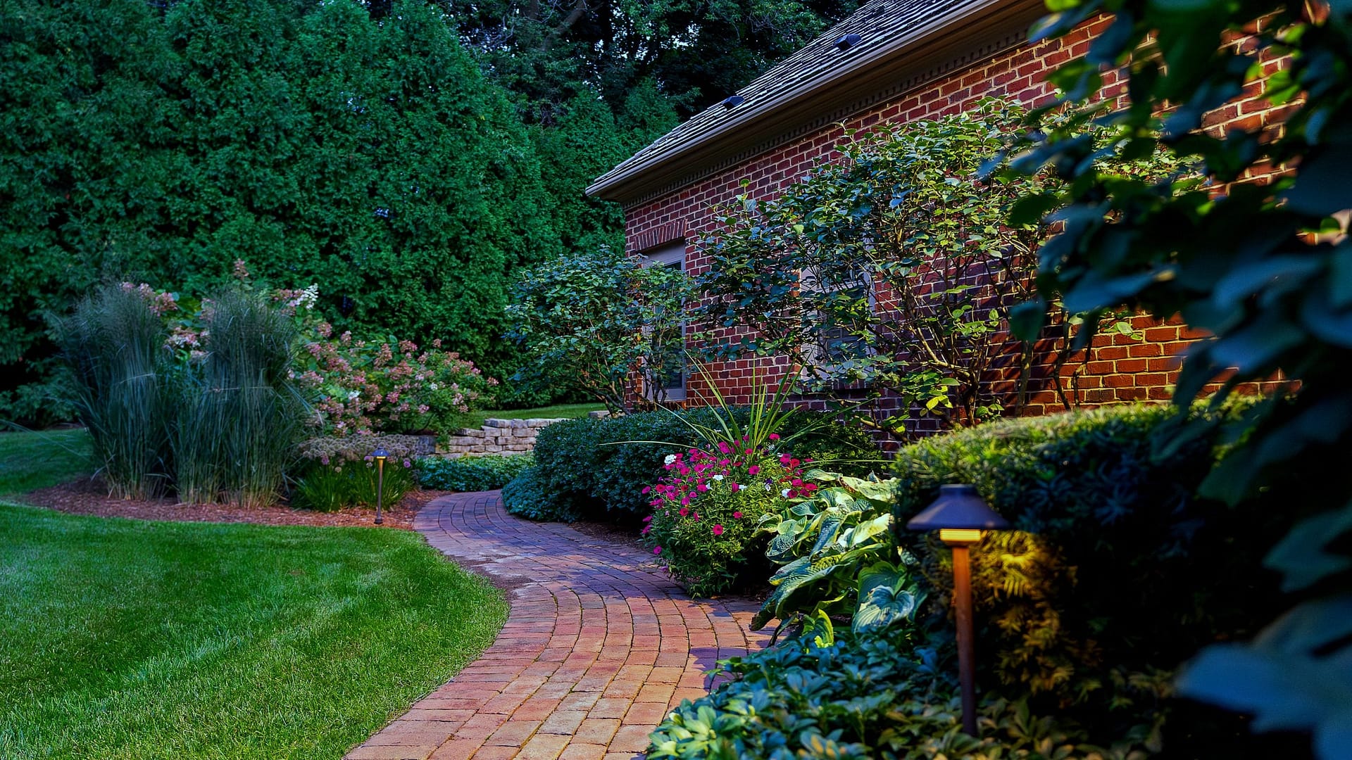 Texture and curvature provide interest as you travel through the garden. The classic and clean spaces mirror the personality of the homeowners as well as the architecture of the house.