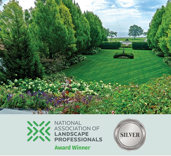 Formal terraced garden overlooking Lake Michigan with manicured lawn and flowering borders