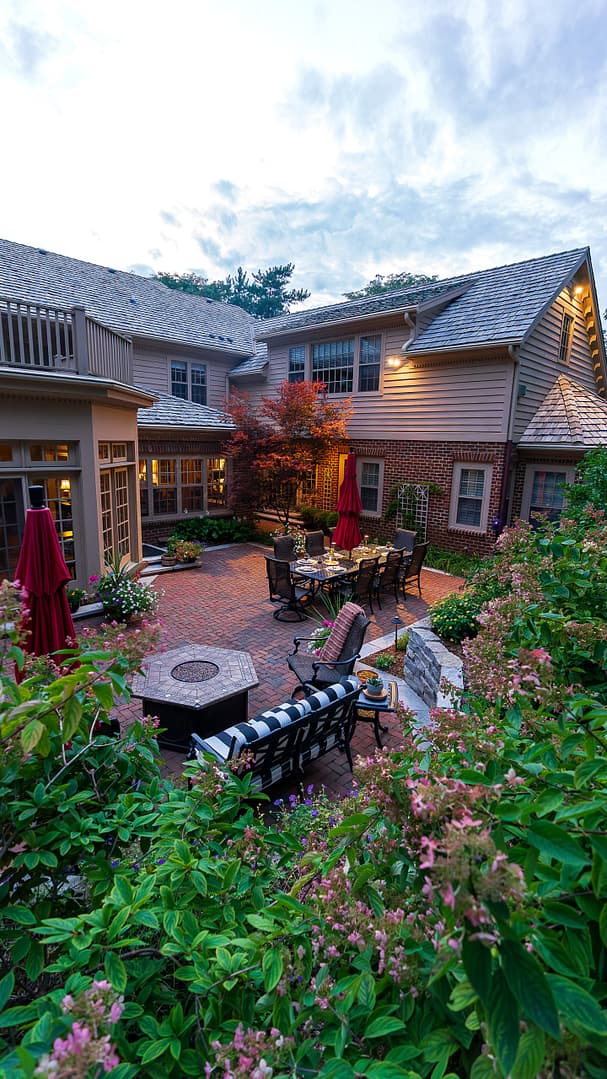 The fire table and seating areas provide warmth and comfort while entertaining guests. Raised container pots provide seasonal color year-round.