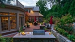 The outdoor kitchen allows for entertaining throughout the entire season and is the perfect spot for hosting large groups of family and friends.
