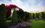 Lush landscaped property with manicured lawn, flowering borders, and ornamental trees in River Hills.