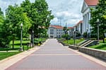 Professionally landscaped college campus in Wisconsin featuring manicured lawns, maintained walkways, mature trees, and welcoming outdoor spaces for students and faculty.
